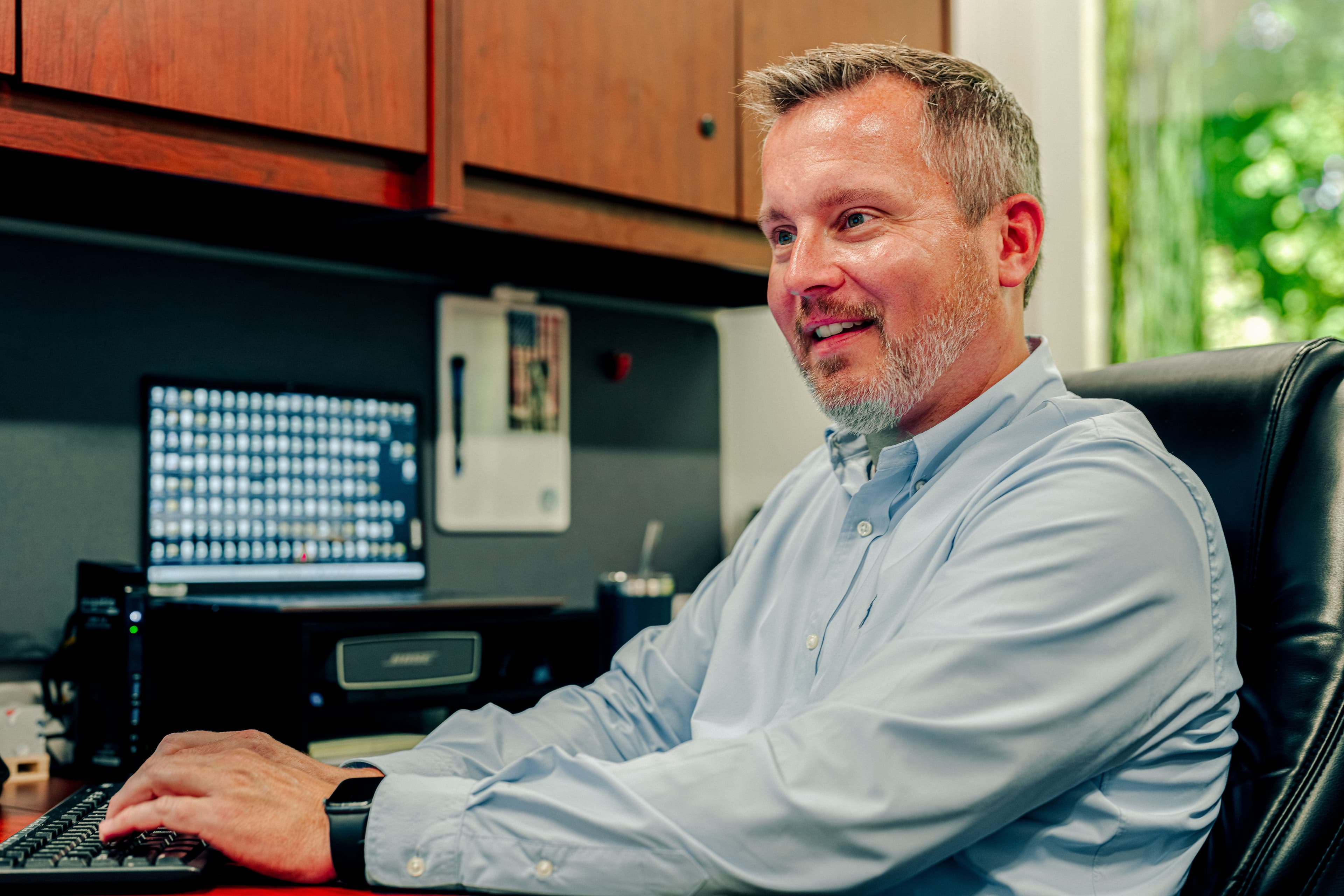 Man working on a laptop at his desk.
