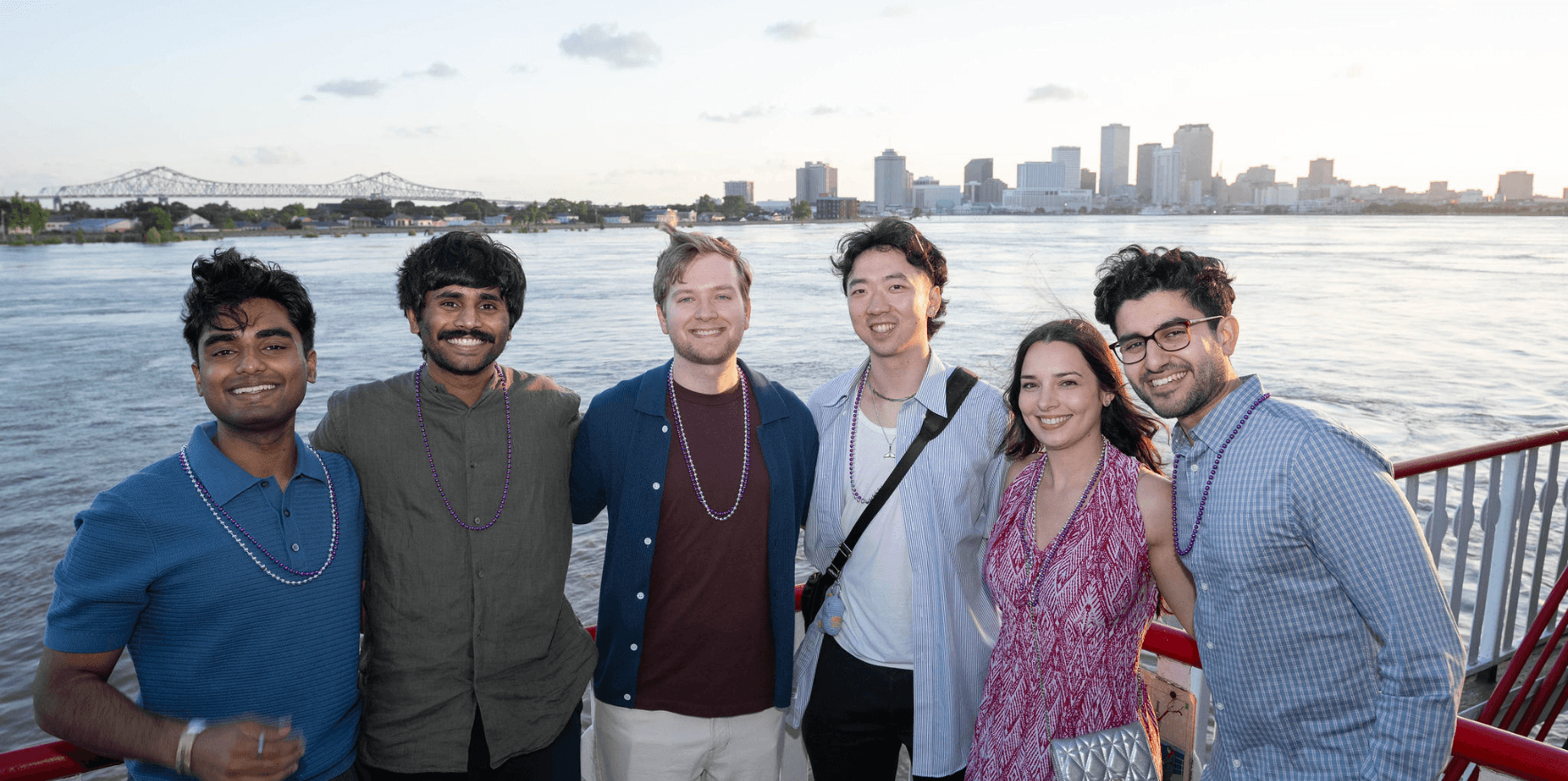 the miter team with the new orleans skyline in the background